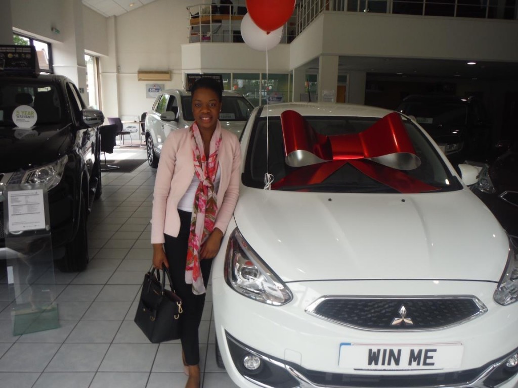 Oyinnoyi Onozutu at North City Autos in Chingford with her new Mitsubishi Mirage, won in a competition with CarTakeBack.com